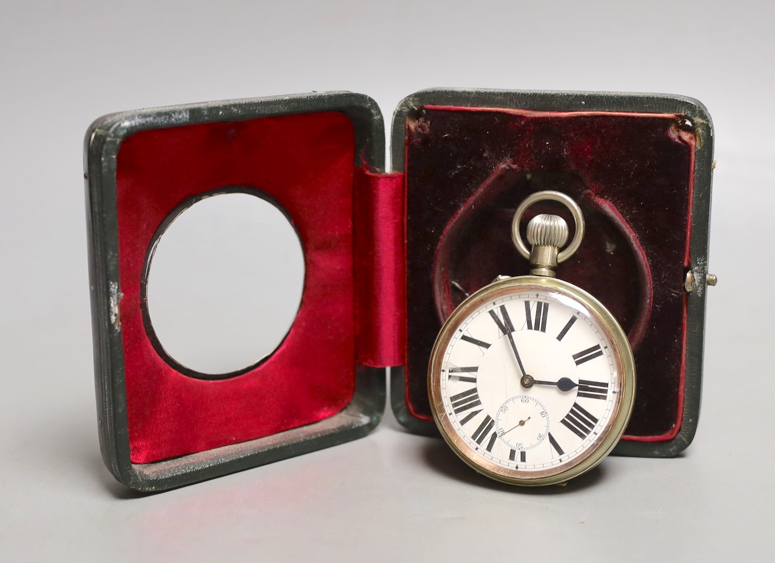 A George V silver and leather travelling watch case, Birmingham, 1917, 11.4cm, with nickel cased Goliath pocket watch.